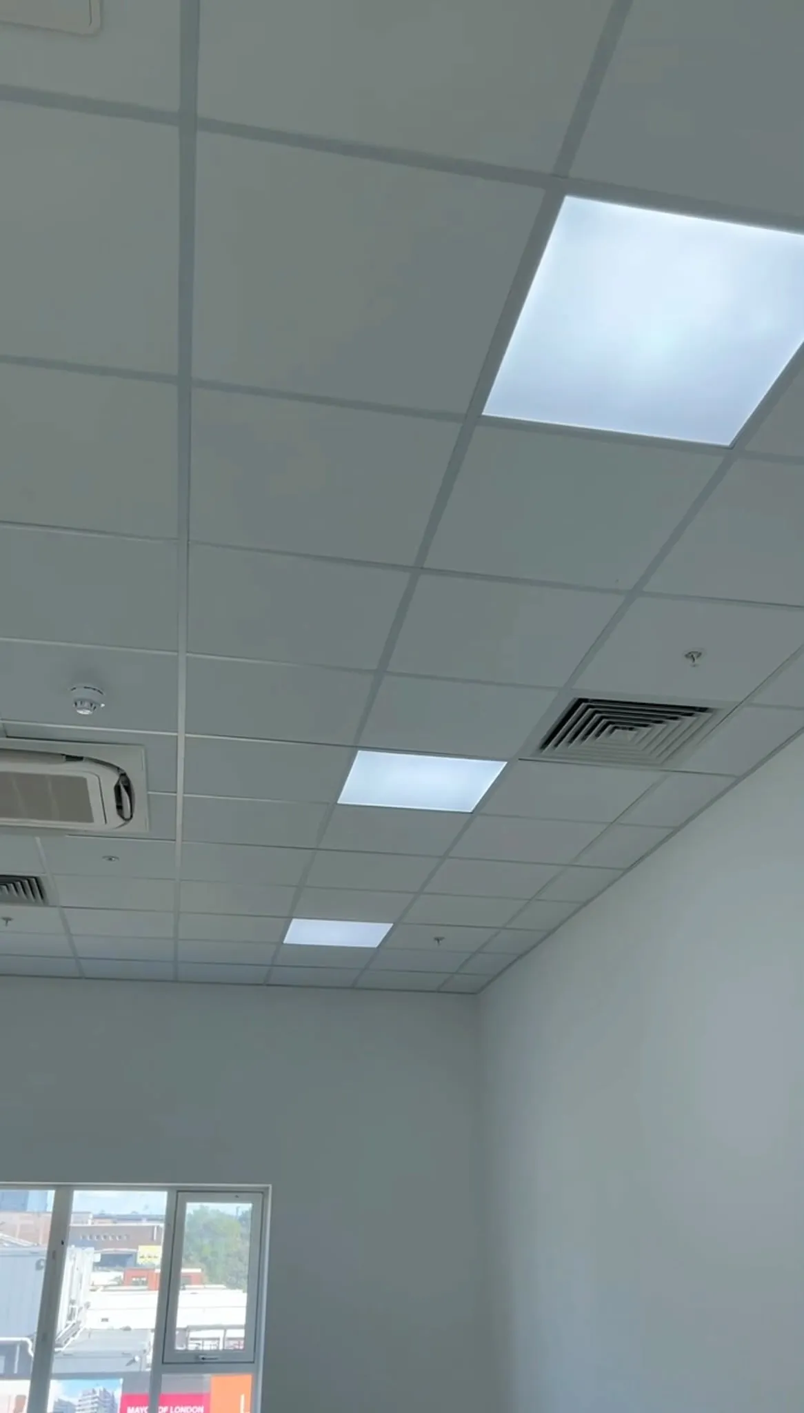 Grid ceiling with services cut in