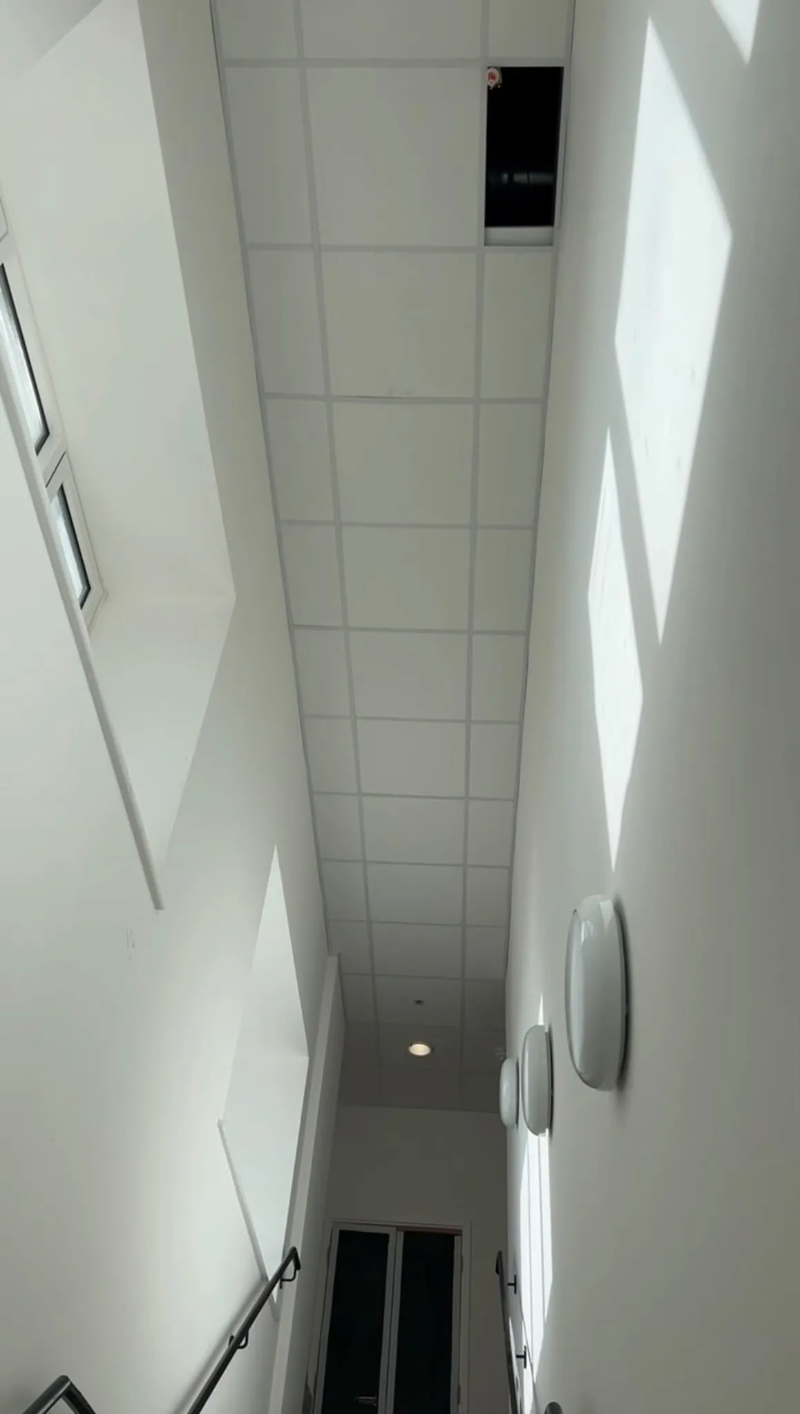 Full-height stairwell with grid ceiling